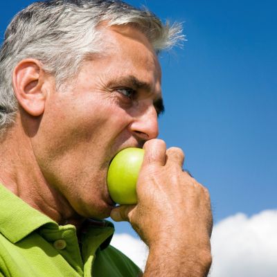 Man biting an apple