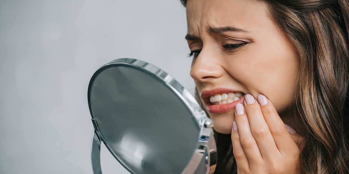 Girl is Looking at Her Painful Teeth by Mirror