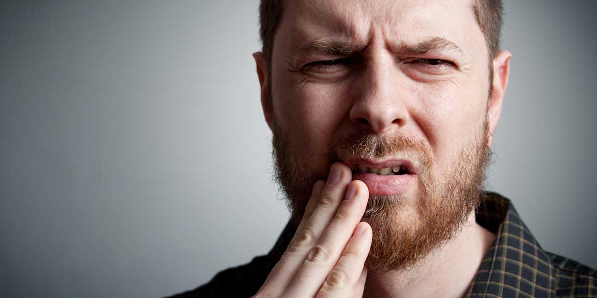 Man is Touching His Painful Mouth